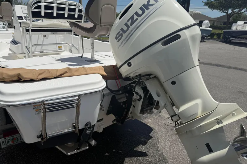 Slide: The Image of 2019 Aquasport 224 Bay boat with Suzuki outboard motor, rear view. - 5