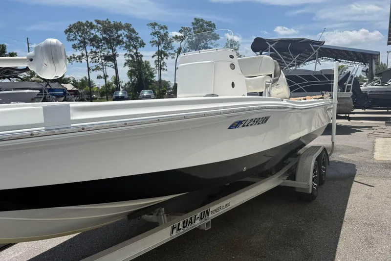 Slide: The Image of 2019 Aquasport 224 Bay boat on trailer under sunny sky. - 7
