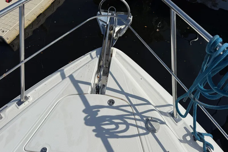 Slide: The Image of Bow of 2002 Cruisers Yachts 4450 Express Motoryacht with anchor and blue rope. - 11