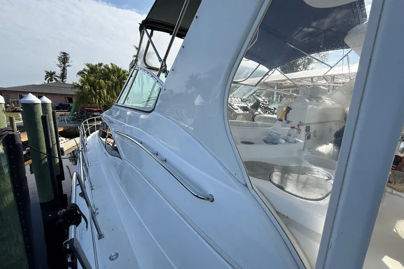 Slide: The Image of 2002 Cruisers Yachts 4450 Express Motoryacht docked, showcasing sleek design and spacious deck. - 15