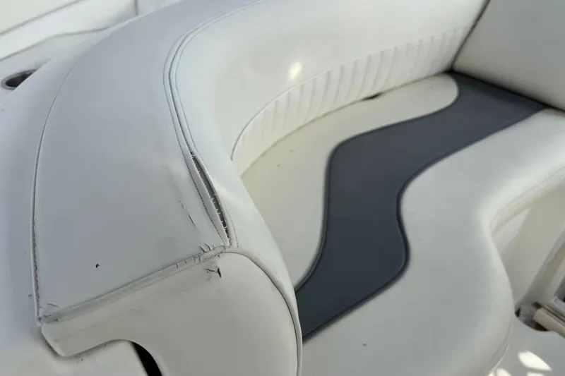 Slide: The Image of White leather seating on 2002 Cruisers Yachts 4450 Express Motoryacht, showing wear and tear. - 19