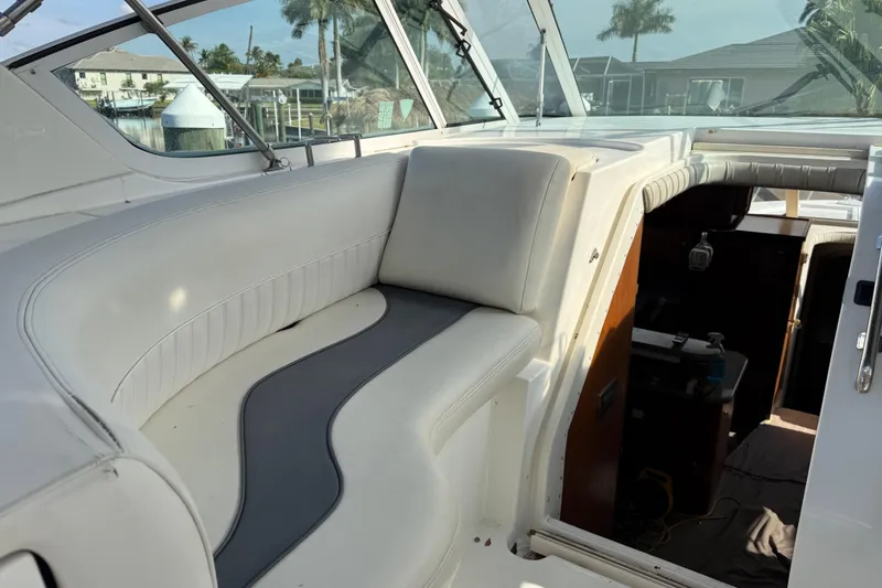 Slide: The Image of 2002 Cruisers Yachts 4450 Express Motoryacht interior with white seating and helm view. - 21