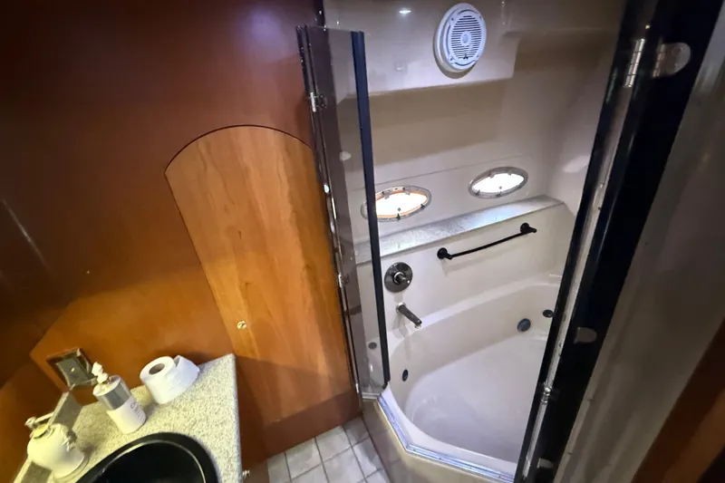 Slide: The Image of Luxurious bathroom in 2002 Cruisers Yachts 4450 Express Motoryacht with shower and portholes. - 24