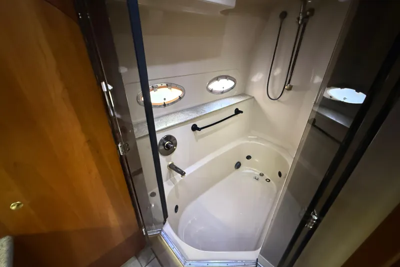 Slide: The Image of Luxurious bathroom in 2002 Cruisers Yachts 4450 Express Motoryacht with shower and porthole. - 25