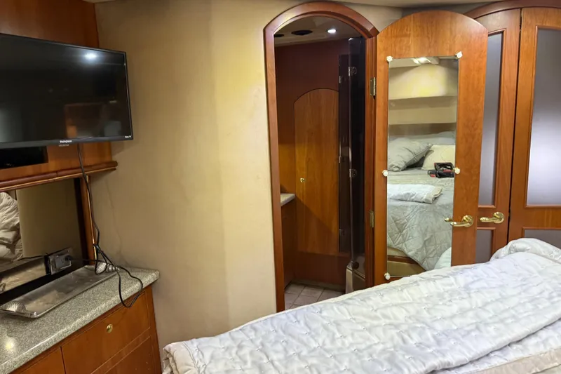 Slide: The Image of Interior of 2002 Cruisers Yachts 4450 Express Motoryacht with TV and cozy bedding. - 26