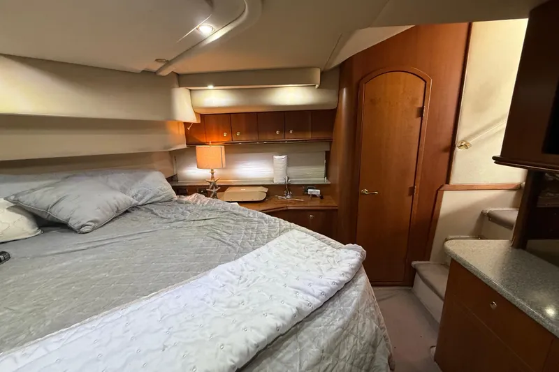 Slide: The Image of Luxurious bedroom interior of 2002 Cruisers Yachts 4450 Express Motoryacht with cozy bedding. - 27