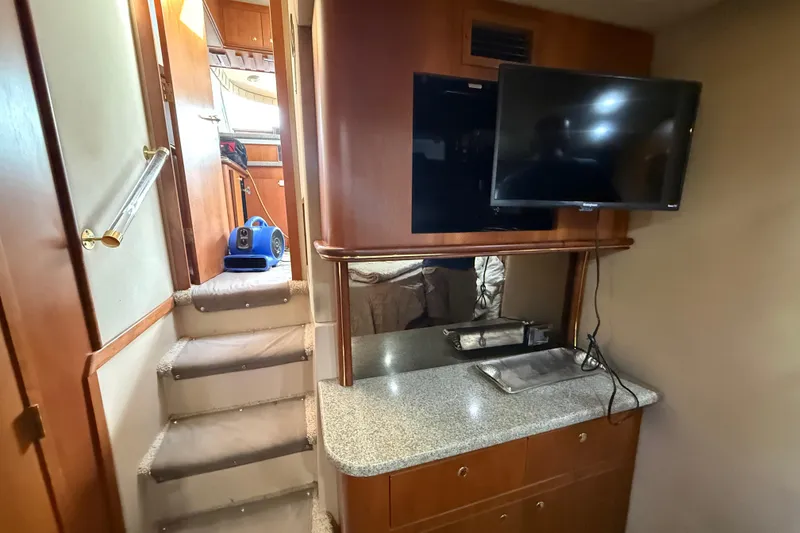 Slide: The Image of Interior of 2002 Cruisers Yachts 4450 Express Motoryacht with TV and stairs. - 28
