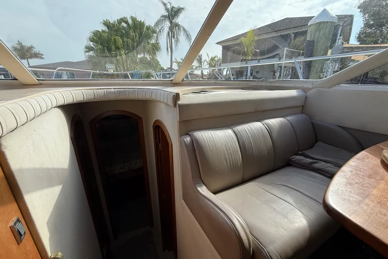 Slide: The Image of Interior of 2002 Cruisers Yachts 4450 Express Motoryacht with leather seating and wooden table. - 31