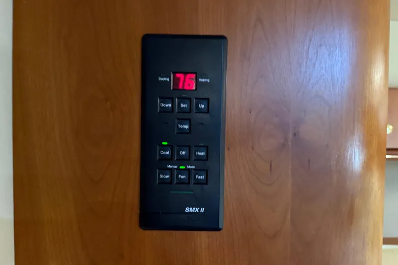 Slide: The Image of Thermostat control panel on 2002 Cruisers Yachts 4450 Express Motoryacht displaying 76 degrees. - 36