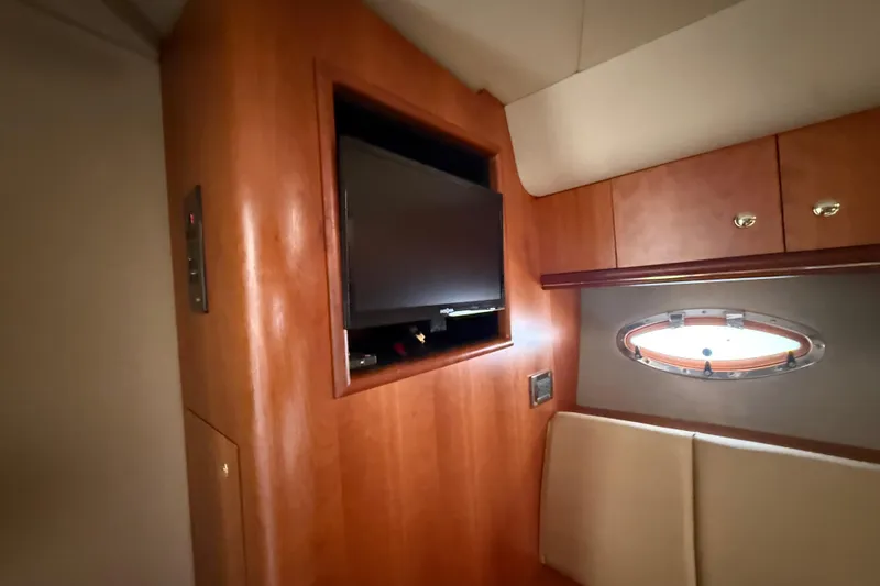 Slide: The Image of Interior of 2002 Cruisers Yachts 4450 Express Motoryacht with TV and porthole window. - 38