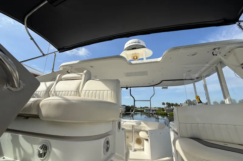Slide: The Image of 2002 Cruisers Yachts 4450 Express Motoryacht interior with white seating and Garmin equipment. - 41