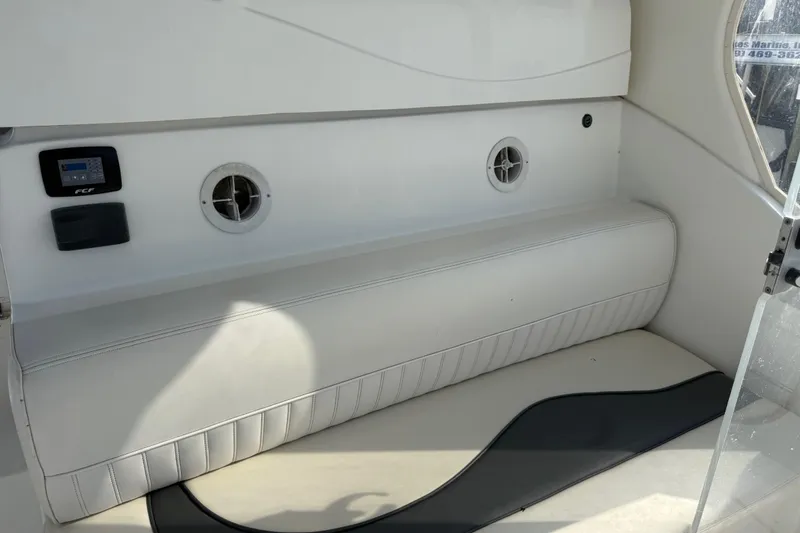 Slide: The Image of Interior seating of 2002 Cruisers Yachts 4450 Express Motoryacht, featuring white upholstery and ventilation. - 46