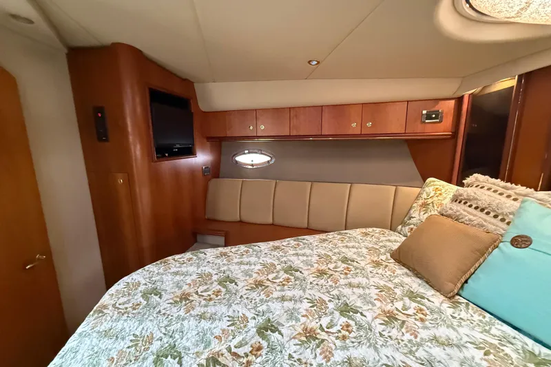 Slide: The Image of Luxurious 2002 Cruisers Yachts 4450 Express Motoryacht bedroom with elegant wood finishes. - 47