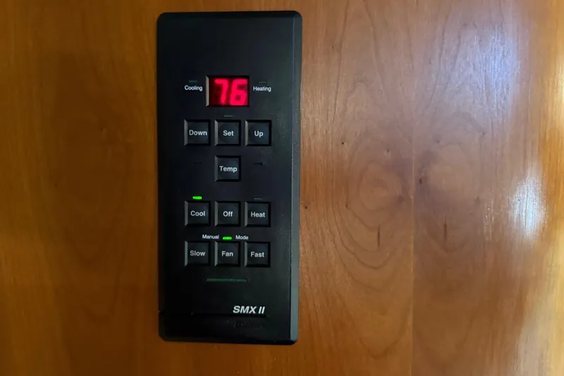 Slide: The Image of Thermostat control panel on 2002 Cruisers Yachts 4450 Express Motoryacht, displaying 76 degrees. - 48