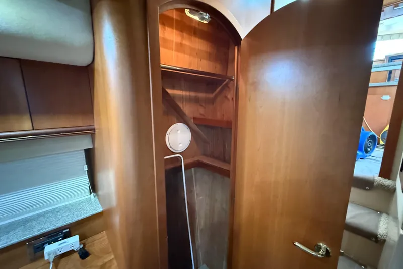 Slide: The Image of Interior of 2002 Cruisers Yachts 4450 Express Motoryacht with open wooden closet. - 51