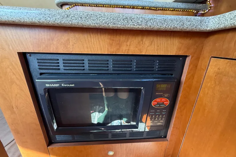Slide: The Image of Built-in Sharp Carousel microwave in 2002 Cruisers Yachts 4450 Express Motoryacht kitchen. - 55