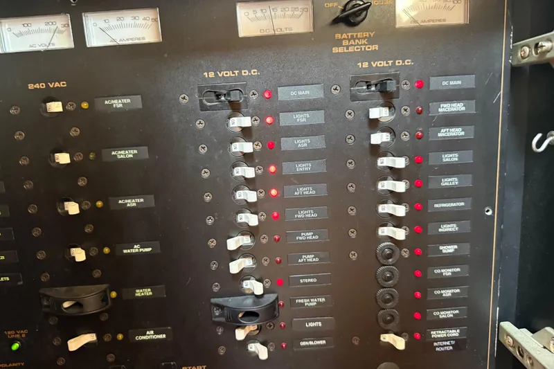Slide: The Image of Electrical panel of a 2002 Cruisers Yachts 4450 Express Motoryacht with various switches and indicators. - 56