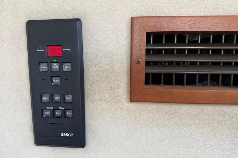 Slide: The Image of Thermostat control panel and vent on 2002 Cruisers Yachts 4450 Express Motoryacht. - 63