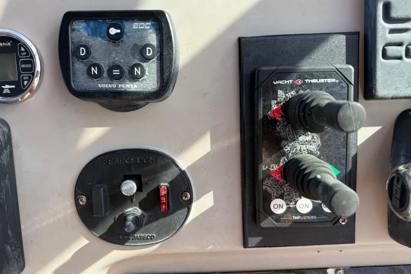 Slide: The Image of Control panel of a 2002 Cruisers Yachts 4450 Express Motoryacht featuring Volvo Penta and Yacht Thruster controls. - 65