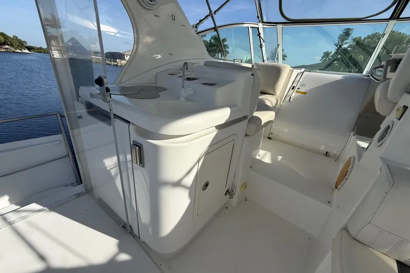Slide: The Image of 2002 Cruisers Yachts 4450 Express Motoryacht interior with sink and seating area. - 66