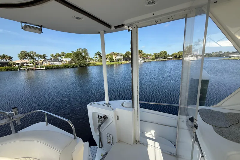 Slide: The Image of 2002 Cruisers Yachts 4450 Express Motoryacht with scenic waterfront view. - 68