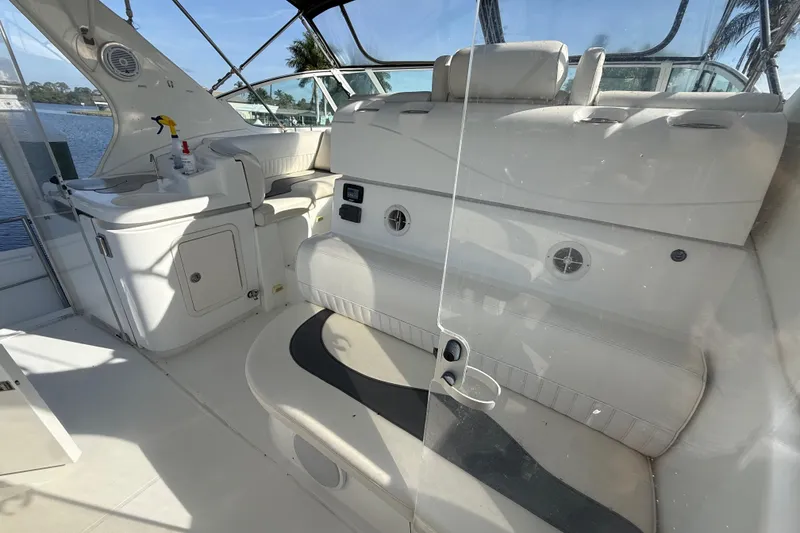 Slide: The Image of 2002 Cruisers Yachts 4450 Express Motoryacht interior with seating and kitchenette, overlooking water. - 70