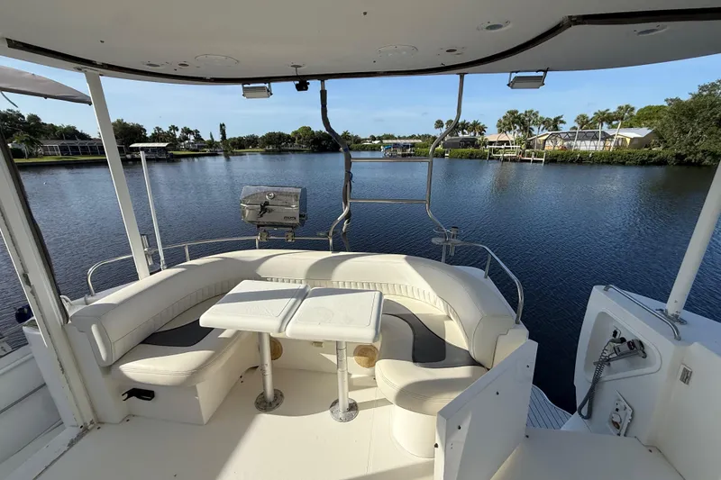 Slide: The Image of 2002 Cruisers Yachts 4450 Express Motoryacht with seating area overlooking serene waterway. - 72