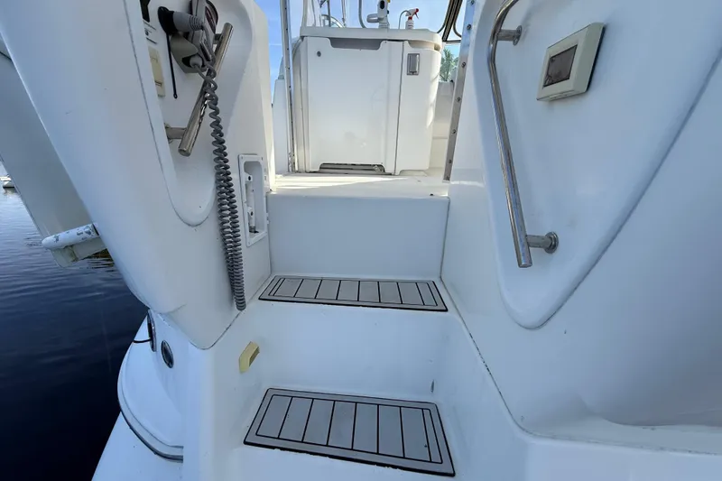 Slide: The Image of Staircase on 2002 Cruisers Yachts 4450 Express Motoryacht, featuring sleek white design and metal handrail. - 74