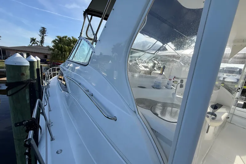 Slide: The Image of 2002 Cruisers Yachts 4450 Express Motoryacht docked, showcasing sleek design and spacious deck. - 75