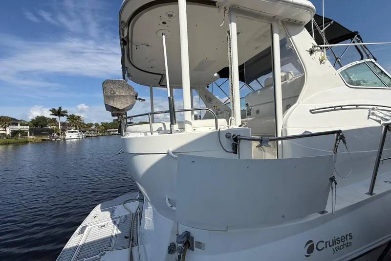 Slide: The Image of 2002 Cruisers Yachts 4450 Express Motoryacht docked on a sunny day. - 9