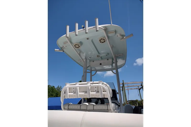 Slide: The Image of 2020 Sportsman Heritage 211 Center Console boat with T-top under clear blue sky. - 12