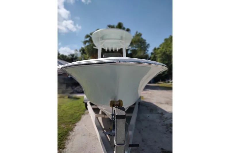 Slide: The Image of 2020 Sportsman Heritage 211 Center Console boat on trailer, sunny day, trees in background. - 18