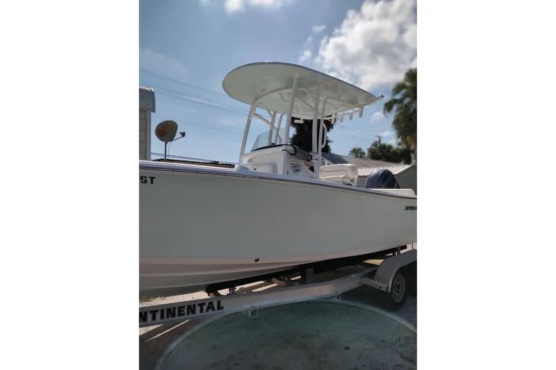 Slide: The Image of 2020 Sportsman Heritage 211 Center Console boat on trailer under clear sky. - 19