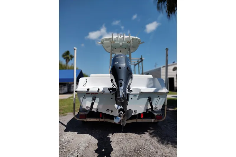 Slide: The Image of 2020 Sportsman Heritage 211 Center Console boat with outboard motor, parked outdoors. - 2