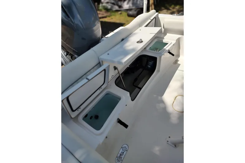 Slide: The Image of 2020 Sportsman Heritage 211 Center Console boat interior with storage compartments open. - 20