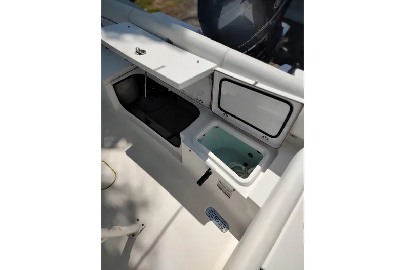Slide: The Image of 2020 Sportsman Heritage 211 Center Console boat interior with open storage compartments. - 22