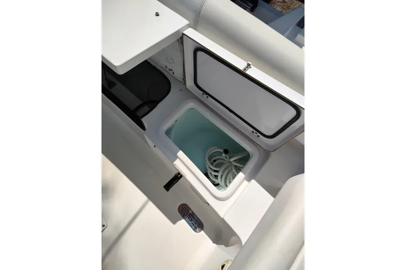 Slide: The Image of Open storage compartment on 2020 Sportsman Heritage 211 Center Console boat. - 23
