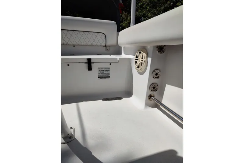 Slide: The Image of Interior view of a 2020 Sportsman Heritage 211 Center Console boat, featuring seating and speakers. - 24