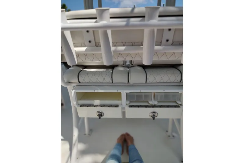 Slide: The Image of 2020 Sportsman Heritage 211 Center Console boat interior with storage compartments and rod holders. - 26