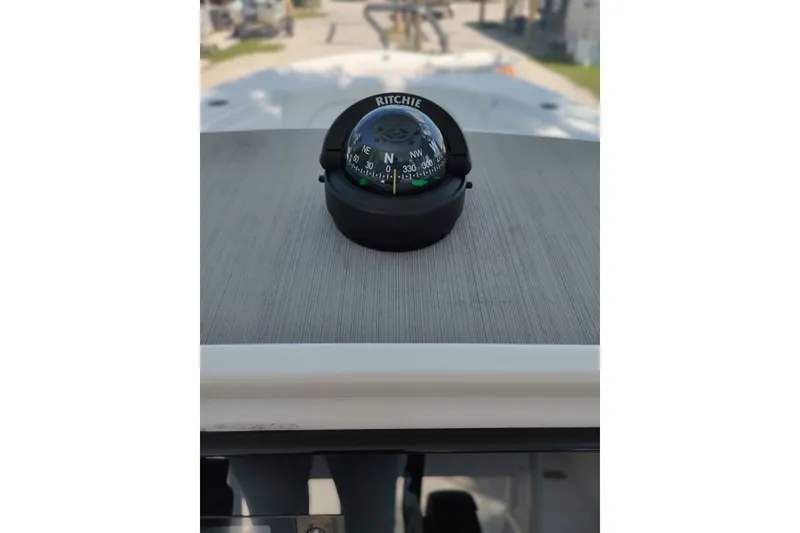 Slide: The Image of Compass on 2020 Sportsman Heritage 211 Center Console boat dashboard. - 28