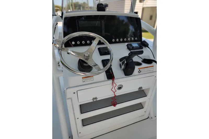 Slide: The Image of Center console of 2020 Sportsman Heritage 211 boat with steering wheel and controls. - 3