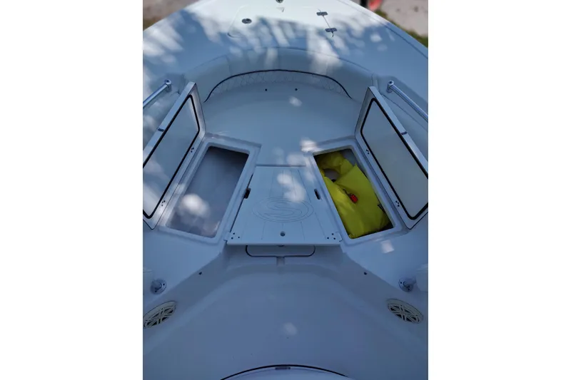 Slide: The Image of 2020 Sportsman Heritage 211 Center Console boat storage compartments open, revealing interior. - 36