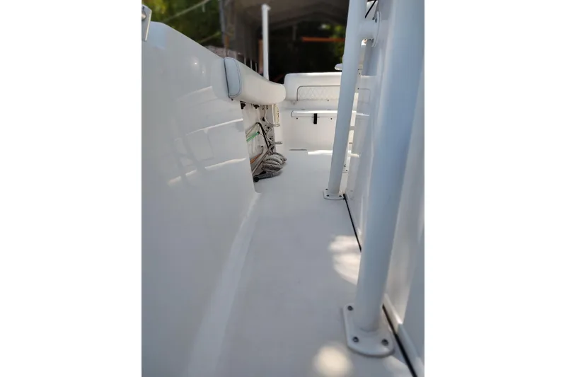 Slide: The Image of 2020 Sportsman Heritage 211 Center Console boat interior, featuring sleek white design and seating. - 37