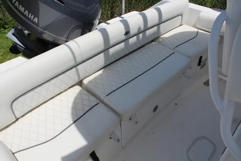 Slide: The Image of 2020 Sportsman Heritage 211 Center Console boat with white cushioned seating and Yamaha engine. - 45