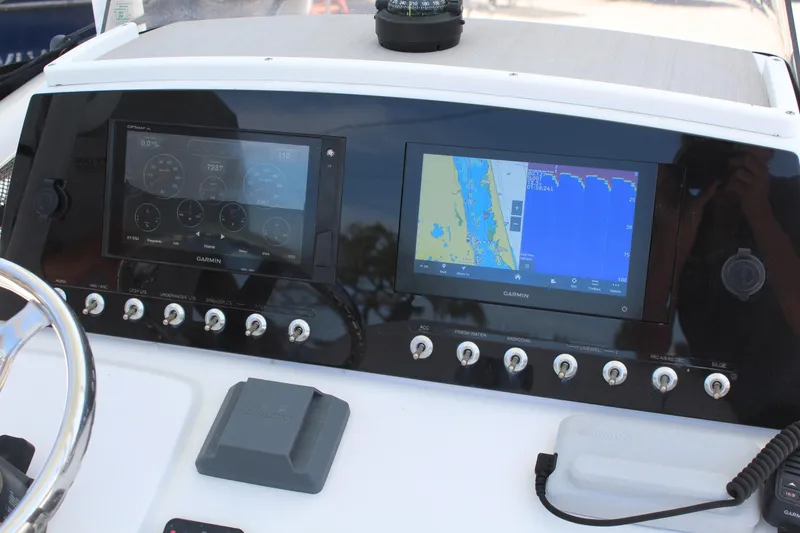 Slide: The Image of 2020 Sportsman Heritage 211 Center Console dashboard with Garmin navigation displays. - 46