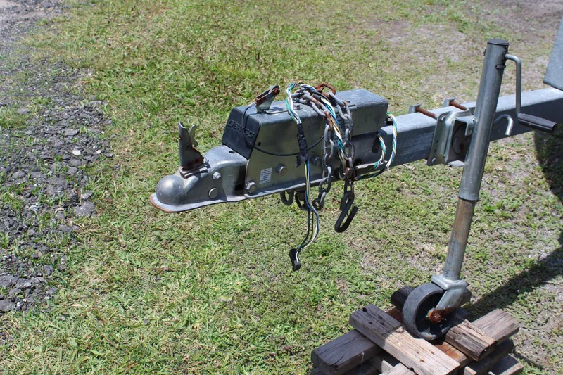 Slide: The Image of Trailer hitch and wiring for 2020 Sportsman Heritage 211 Center Console on grassy surface. - 50