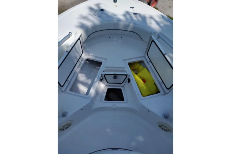 Slide: The Image of 2020 Sportsman Heritage 211 Center Console boat with open storage compartments. - 6