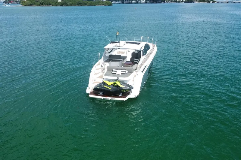 Slide: The Image of 2018 Azimut Atlantis 43 yacht with jet ski on deck, cruising in clear blue waters. - 4