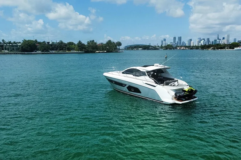 Slide: The Image of Azimut Atlantis 43 yacht on turquoise water with city skyline in background, 2018 model. - 6