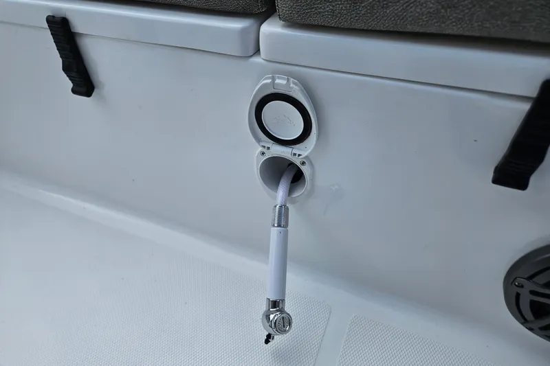 Slide: The Image of Close-up of a 2026 Sea Hunt Ultra 245 SE boat's hose connection feature. - 10